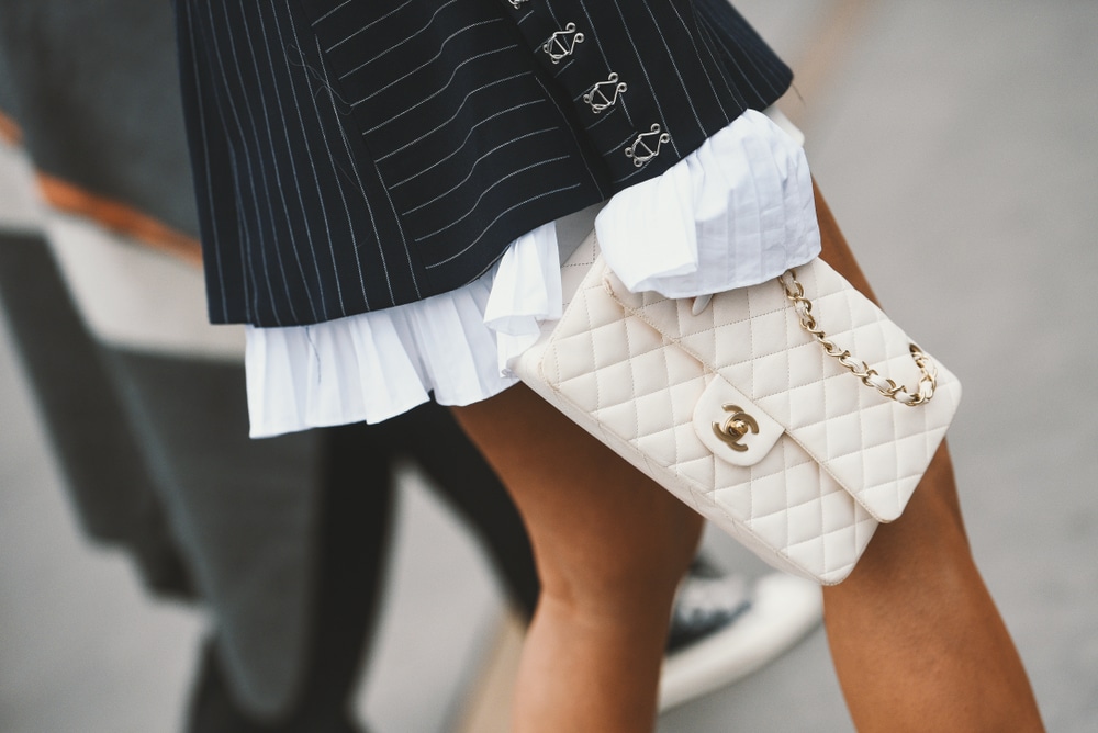 16 Best Designer Bags That Are Always On Trend According to Bagover Editors 16 chanel classic flap in white with blazer and skirt gold hardware